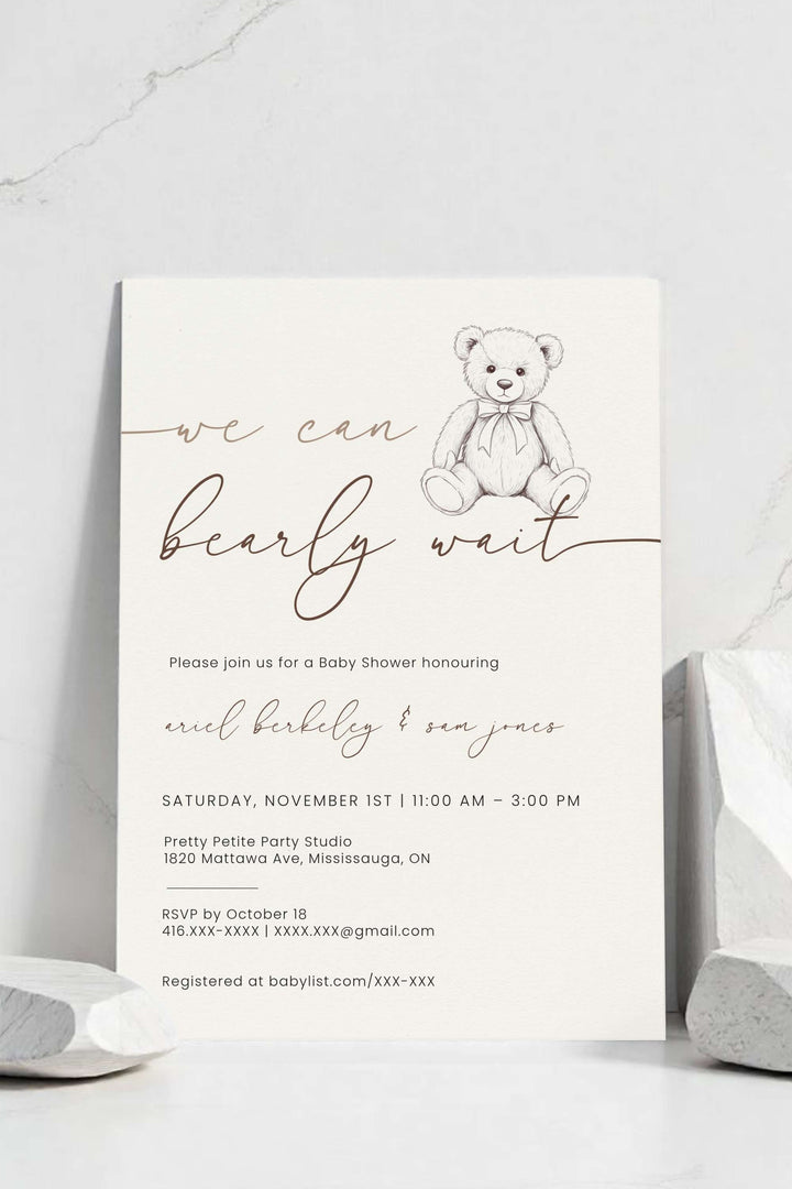 Baby shower invitation with teddy bear graphic on a white background