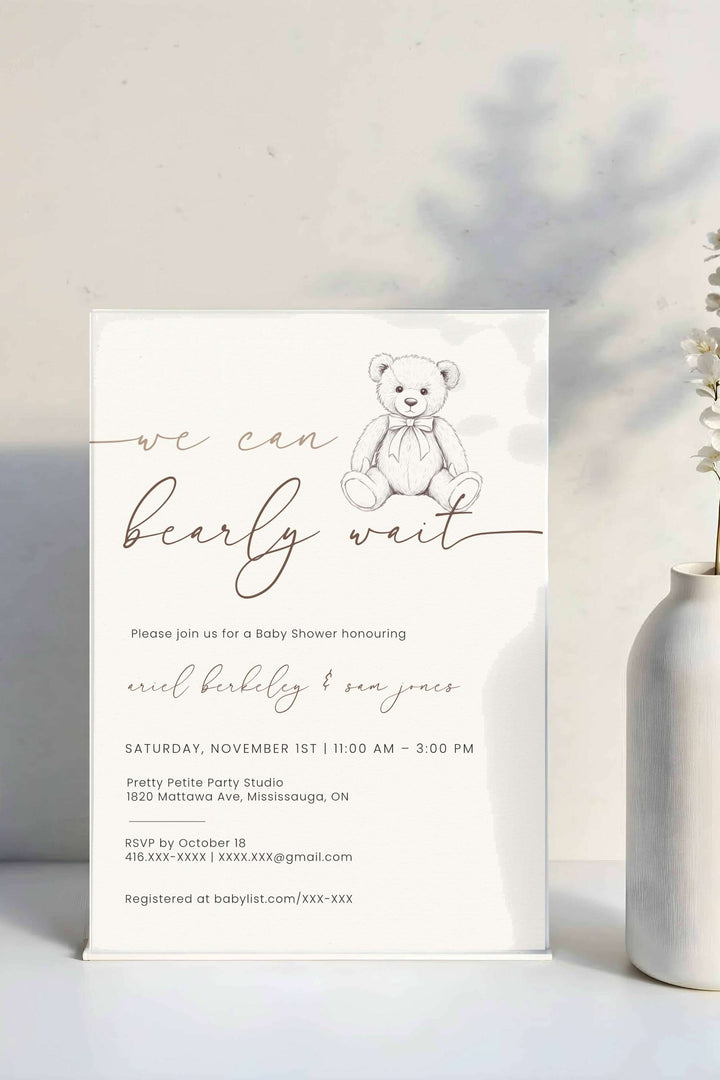 Baby shower invitation with teddy bear illustration on a white background